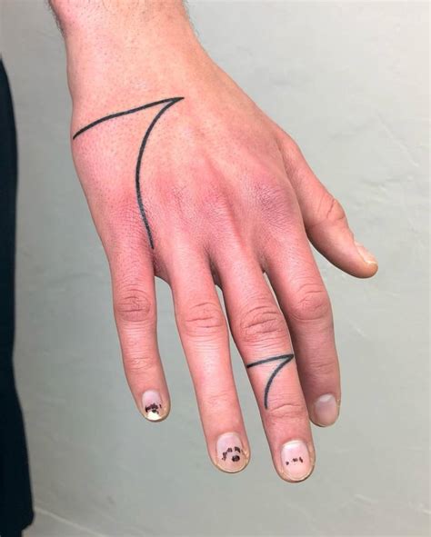 Minimalistic line art tattoo located on the hand.