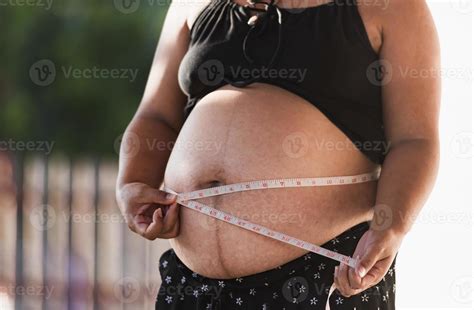 pregnant woman measuring tape around protuberant abdomen. 13958955 Stock Photo at Vecteezy