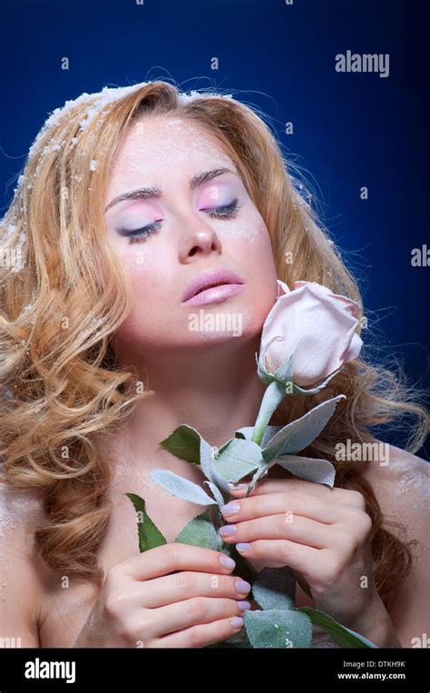 Young frozen girl with rose flower Stock Photo - Alamy