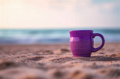 Purple Mug Mockup in the Sand Sea Graphic by imagify design · Creative Fabrica