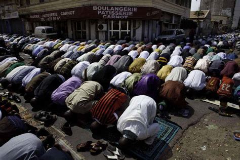 Senegal men praying | PassBlue