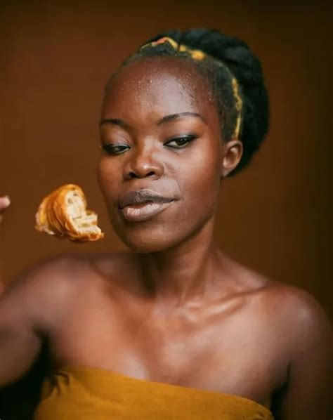 ghanaian woman eating croissant | OpenArt