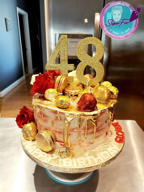 a birthday cake with gold decorations and the number forty four on it's top
