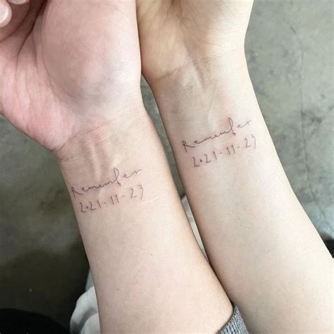 Couple matching tattoo of the word "remember" and