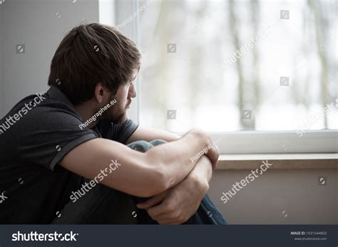 Sad Young Man Sitting On Floor Stock Photo (Edit Now) 1931544803