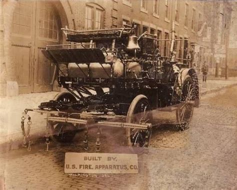 an old time fire engine is parked on the street