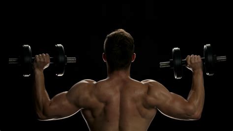 Muscular Man Lifting Dumbbells Young Man Stock Footage SBV-321723522 - Storyblocks