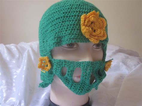 Green knight helmet decorated with goldyellow flowersHouse