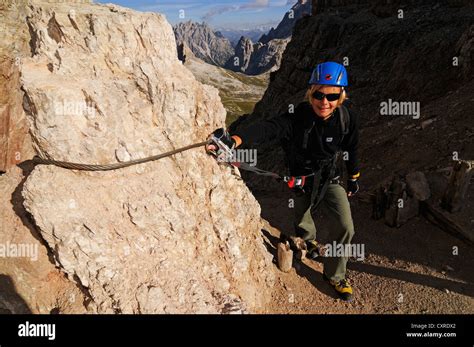 Teenager climbing on the Paternkofel fixed rope route, Hochpustertal valley, Dolomites, Province ...