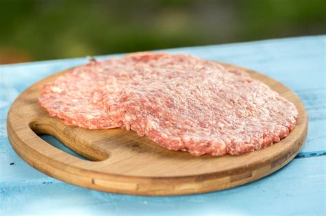 Raw Minced Meat Burgers on the Wooden Round Kitchen Board Stock Image - Image of plate, fresh ...