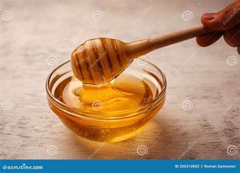 Viscous Transparent Honey is Taken with a Wooden Mace for Honey Stock ...