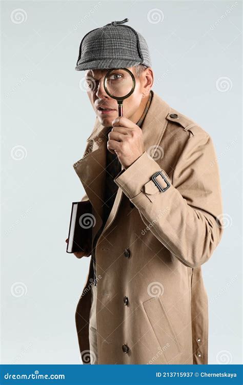 Male Detective Looking through Magnifying Glass on Grey Background ...