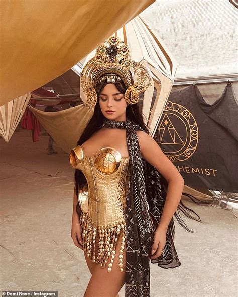 Demi Rose looks incredible in a gold metal corset and statement headdress as she wears an ...