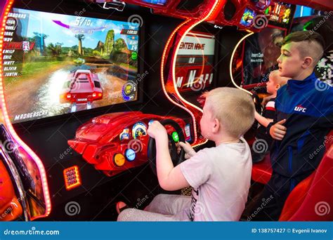 Children and Adults Play on the Slot Machines, Attractions in the Shopping Center. Families with ...