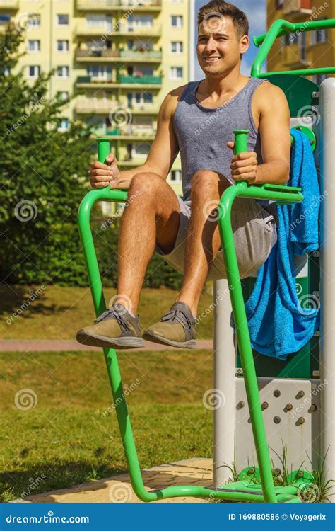 Man Doing Sit Ups in Outdoor Gym Stock Photo - Image of male, weight: 169880586