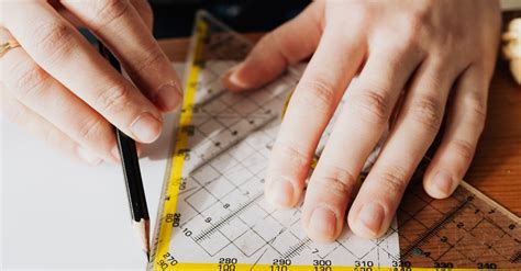 Photo Of Person Using Ruler · Free Stock Photo