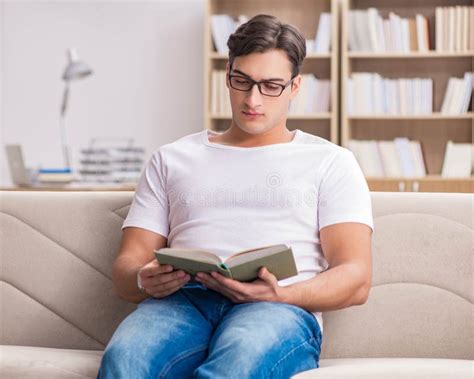 Man Reading Book Sitting in Couch Sofa Stock Photo - Image of house ...