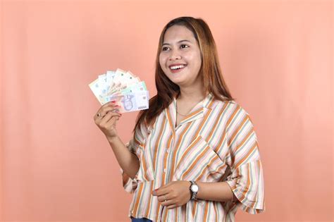 Premium Photo | Holding cash money in Indonesian rupiah