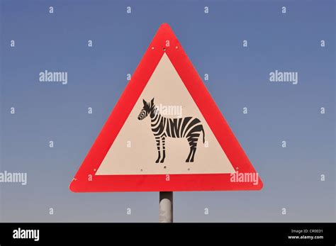 Warning sign for zebras at the entrance of the Namib Rand Nature Reserve, Namib Desert, Namibia ...