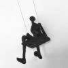 Swinging man wall sculpture