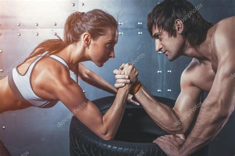 Athlete muscular sportsmen man and woman with hands clasped arm ...