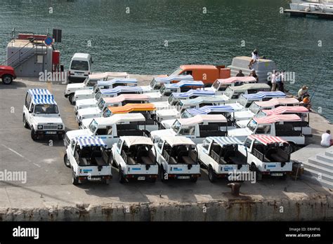 24 Maruti Suzuki Gypsy off road tour vehicles wait on the quayside of Mgarr harbour Gozo for the ...