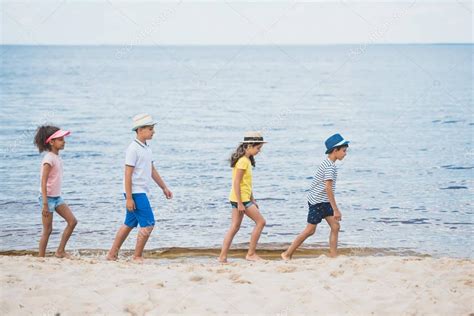 Multicultural kids walking on beach — Stock Photo © alebloshka #160970464