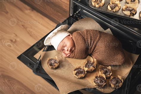 Newborn baby wearing chef's hat is lying on the oven tray with a muffins 16249144 Stock Photo at ...