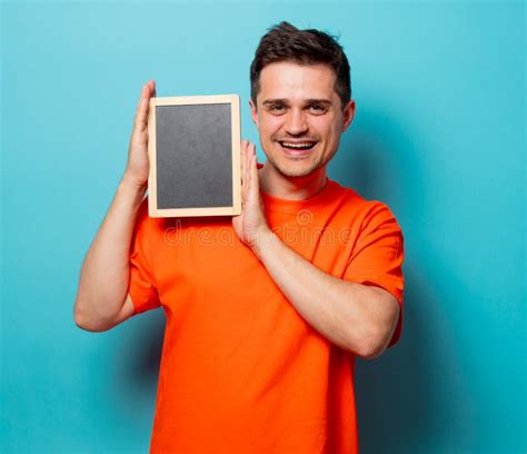 Man in Orange T-shirt with Big Clock Stock Image - Image of dial, cheerful: 122853159