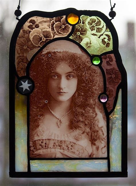a stained glass window with an image of a woman