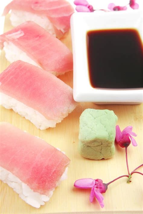 Sushi topped with raw Tuna stock photo. Image of piece - 24180140