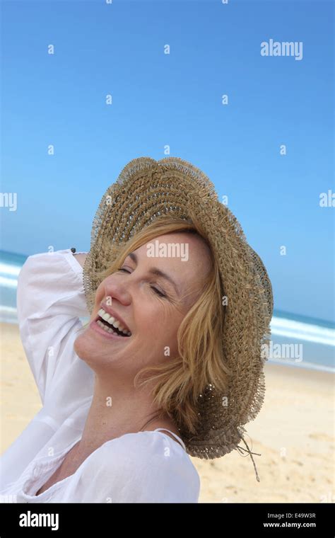 Woman laughing on the beach Stock Photo - Alamy