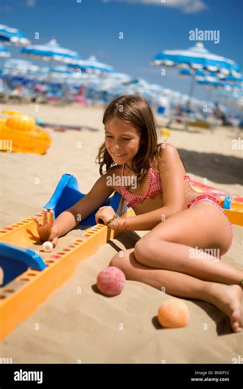 8/10 years old girl playing at the beach Stock Photo - Alamy