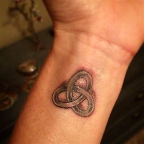 Neat small wrist tattoo. It's like a Gordian knot but more like a love ...