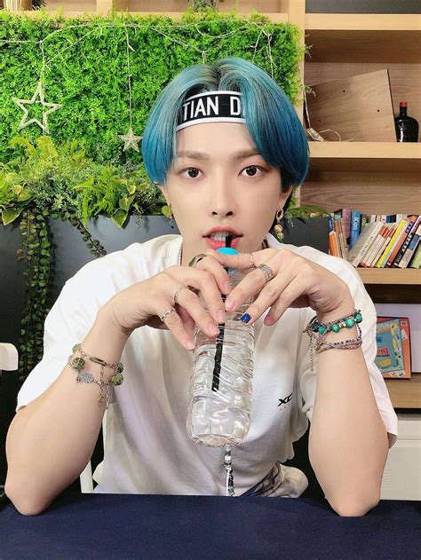 a person with blue hair holding a water bottle