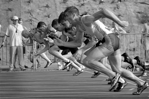 athletes-running-on-track-and-field-oval-in-grayscale-34514