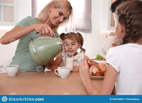 Happy Family Eating Together at Table in Modern Kitchen Stock Image - Image of background ...