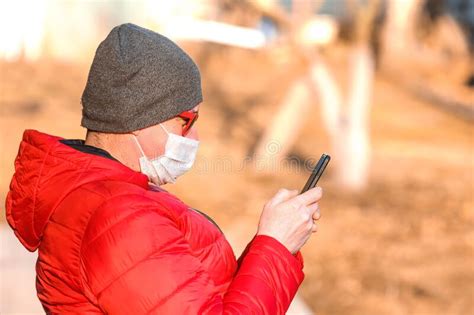 A Man in a Medical Mask is Typing on a Smartphone Stock Image - Image of 2019ncov, prevention ...