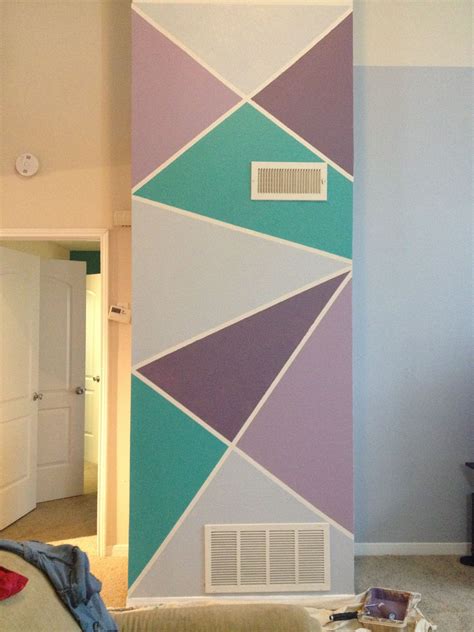 a living room with a wall painted in different colors