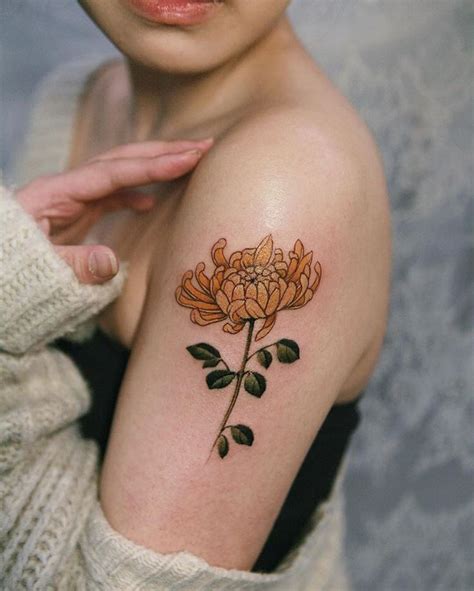 Yellow chrysanthemum on her arm, done in New York in January. #tattooists… | Tatuagens de flores ...