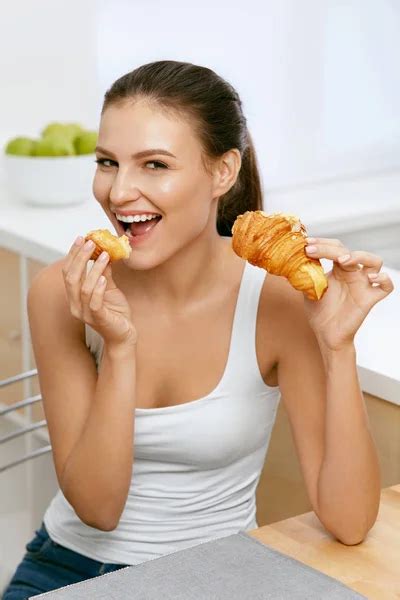 Diet. Happy Woman Eating Croissant For Breakfast. - Stock Image - Everypixel