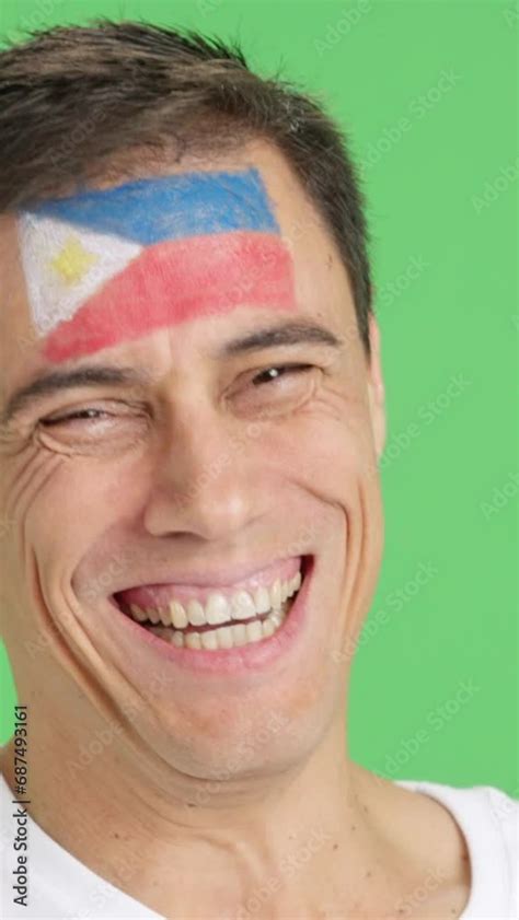 Man with a philippine flag painted on the face smiling Stock Video | Adobe Stock