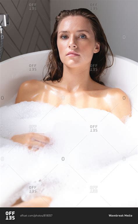 Close-up of beautiful woman bathing in the bathtub in bathroom stock photo - OFFSET