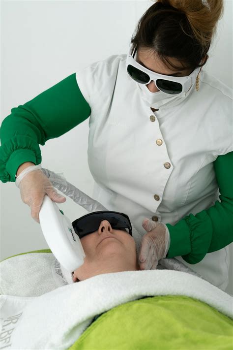 Doctor making face procedure with laser tool · Free Stock Photo