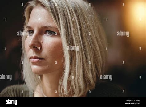 Thoughtful young woman in coffee shop Stock Photo - Alamy