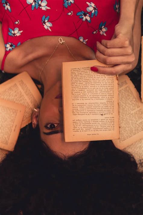 Woman Covering Half of Her Face with a Book · Free Stock Photo