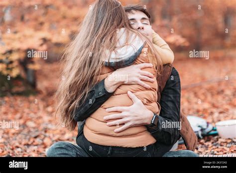 Young, romantic couple in tight embrace in the woods. Autumn time Stock ...