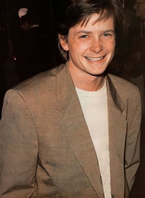 a man in a suit smiling at the camera