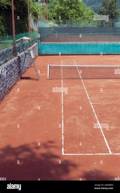 red clay tennis court in a mountain resort area Stock Photo - Alamy