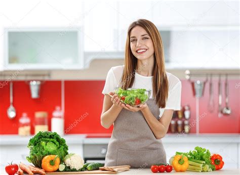 Woman cooking healthy food Stock Photo by ©belchonock 119685764